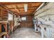 This garage interior has wood paneling, concrete floors, work benches, and wire shelves for storage at 515 Frank Lloyd Wright Way, Lakeland, FL 33803
