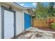 Detached garage has blue doors and a light gray trim at 515 Frank Lloyd Wright Way, Lakeland, FL 33803