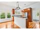 Bright kitchen features wooden cabinetry, stainless steel appliances, granite countertops, and ample natural light at 515 Frank Lloyd Wright Way, Lakeland, FL 33803