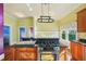 Modern kitchen featuring an island cooktop, updated appliances, and hardwood floors at 515 Frank Lloyd Wright Way, Lakeland, FL 33803