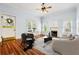 Bright living room featuring hardwood floors, fireplace, ceiling fan, and a contemporary design at 515 Frank Lloyd Wright Way, Lakeland, FL 33803