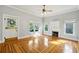 Bright living room featuring gleaming hardwood floors, natural light, and a classic fireplace at 515 Frank Lloyd Wright Way, Lakeland, FL 33803