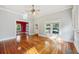 Inviting living room with hardwood floors, natural light, and an adjacent red-walled room at 515 Frank Lloyd Wright Way, Lakeland, FL 33803