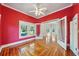 Bright living room featuring large windows and decorative wood flooring at 515 Frank Lloyd Wright Way, Lakeland, FL 33803
