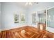 Bright living room with hardwood floors, large windows, and double glass doors to another room at 515 Frank Lloyd Wright Way, Lakeland, FL 33803
