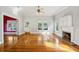 Bright living room features hardwood floors, fireplace, and abundant natural light from the windows at 515 Frank Lloyd Wright Way, Lakeland, FL 33803