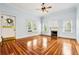 Cozy living room with a decorative fireplace, hardwood floors, and natural light at 515 Frank Lloyd Wright Way, Lakeland, FL 33803