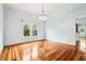 Open living room featuring a chandelier, large window, and patterned hardwood flooring throughout at 515 Frank Lloyd Wright Way, Lakeland, FL 33803