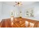 Bright living room with gleaming hardwood floors, large windows, and classic trim at 515 Frank Lloyd Wright Way, Lakeland, FL 33803