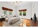 Relaxing main bedroom with natural light, hardwood floors, and bamboo window shades at 515 Frank Lloyd Wright Way, Lakeland, FL 33803