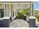 Spacious, covered porch with concrete tile, offering shade and a stylish outdoor area at 515 Frank Lloyd Wright Way, Lakeland, FL 33803