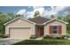 Charming single-Gathering home featuring a well-maintained lawn, neutral stucco, and complementary dark brown shutters at 2434 Slippery Rock St, Auburndale, FL 33823