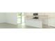 The gourmet kitchen has modern appliances, white cabinetry, and center island, all overlooking an inviting outdoor space at 2434 Slippery Rock St, Auburndale, FL 33823