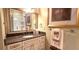 Bathroom with a granite countertop vanity, framed mirror, and a glass-enclosed shower, combining style and functionality at 472 Blue Heron Cir, River Ranch, FL 33867