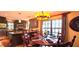 Eat-in kitchen featuring warm lighting, breakfast bar, stainless appliances, and wood flooring at 472 Blue Heron Cir, River Ranch, FL 33867