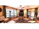 Inviting living room featuring a stone fireplace, hardwood floors, and lots of natural light from the large window at 472 Blue Heron Cir, River Ranch, FL 33867