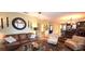 Open-concept living room with hardwood flooring, a round glass table, and neutral furniture at 472 Blue Heron Cir, River Ranch, FL 33867