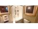 Tiled shower stall with glass door, multiple shower heads, and built-in shelving, perfect for a luxurious experience at 472 Blue Heron Cir, River Ranch, FL 33867