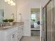 Well-lit bathroom featuring a dual sink vanity, granite counters, and a separate glass enclosed shower at 8237 Sw 52Nd Lane Rd, Ocala, FL 34481