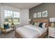 Bright bedroom featuring a bed with wooden headboard, neutral walls and large window with neighborhood views at 8237 Sw 52Nd Lane Rd, Ocala, FL 34481