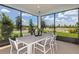 Covered patio with outdoor dining set overlooking beautifully landscaped neighborhood at 8237 Sw 52Nd Lane Rd, Ocala, FL 34481
