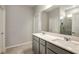 Modern bathroom with double sinks, gray cabinets, quartz counters and tiled shower at 8249 Sw 52Nd Lane Rd, Ocala, FL 34481