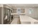 Well-lit kitchen featuring stainless steel appliances, gray cabinets, and a spacious center island at 8249 Sw 52Nd Lane Rd, Ocala, FL 34481