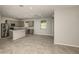 Modern kitchen open to dining area, featuring stainless steel appliances, gray cabinets and a center island at 8249 Sw 52Nd Lane Rd, Ocala, FL 34481