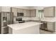 Modern kitchen featuring stainless steel appliances, gray cabinets and a center island at 8249 Sw 52Nd Lane Rd, Ocala, FL 34481
