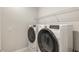 Modern laundry room equipped with a new washer and dryer set, complemented by overhead shelving at 8249 Sw 52Nd Lane Rd, Ocala, FL 34481