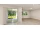 Bright living room with tile floors, sliding glass doors to the backyard, and recessed lighting at 8249 Sw 52Nd Lane Rd, Ocala, FL 34481