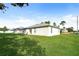 Home exterior with a wide lawn in the backyard at 143 Inconnu Ct, Kissimmee, FL 34759
