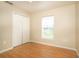 This bedroom has a window, closet, fan and wood floors at 143 Inconnu Ct, Kissimmee, FL 34759