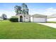 Charming single-story home with lush green lawn and attached two car garage at 143 Inconnu Ct, Kissimmee, FL 34759