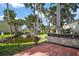 Serene backyard with lush landscaping and a tranquil pond at 2249 Cypress Cove Dr # E3, Tavares, FL 32778