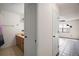 Hallway view of bathroom showcasing vanity, vessel sink, and modern fixtures at 2249 Cypress Cove Dr # E3, Tavares, FL 32778