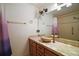 Bathroom featuring a unique vessel sink, a large mirror, and tile countertops at 2249 Cypress Cove Dr # E3, Tavares, FL 32778