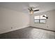 Spacious bedroom featuring a ceiling fan, large window, and tiled flooring at 2249 Cypress Cove Dr # E3, Tavares, FL 32778