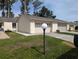 Charming single-story home with a well-manicured lawn and attached two-car garage at 2249 Cypress Cove Dr # E3, Tavares, FL 32778