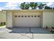 Attached two-car garage with white door at 2249 Cypress Cove Dr # E3, Tavares, FL 32778