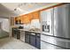 Modern kitchen with stainless steel appliances, granite countertops, and ample storage at 2249 Cypress Cove Dr # E3, Tavares, FL 32778