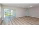 Spacious living room featuring luxury vinyl flooring and sliding glass doors to the backyard at 5408 Sw 85Th Avenue Rd, Ocala, FL 34481