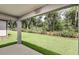 Expansive backyard view from the covered patio, featuring lush greenery and trees at 5433 Sw 82Nd Ter, Ocala, FL 34481