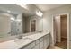 Bathroom featuring double vanity with quartz countertop, walk-in shower with white subway tile and a linen closet at 5433 Sw 82Nd Ter, Ocala, FL 34481