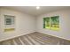 Cozy bedroom with neutral carpet, recessed lighting, and two windows offering natural light at 5433 Sw 82Nd Ter, Ocala, FL 34481