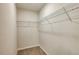 Small walk-in closet featuring wire shelving and neutral carpet at 5433 Sw 82Nd Ter, Ocala, FL 34481