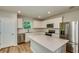 Bright kitchen featuring white cabinets, quartz countertops, stainless steel appliances, and a center island at 5433 Sw 82Nd Ter, Ocala, FL 34481