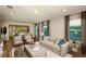 Bright living room seamlessly connects to an open-concept kitchen and dining area at 5433 Sw 82Nd Ter, Ocala, FL 34481