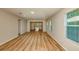 Spacious living room featuring wood-look flooring, recessed lighting, and multiple windows bringing in natural light at 5433 Sw 82Nd Ter, Ocala, FL 34481