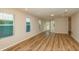 Bright living room featuring wood-look flooring, recessed lighting, and multiple windows bringing in natural light at 5433 Sw 82Nd Ter, Ocala, FL 34481